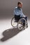 Man on wheelchair casting shadow