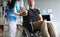 Man on wheelchair holds dumbbell in his hands