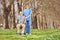 Man in a wheelchair and male nurse posing in park