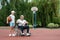 A man in a wheelchair plays basketball with his son on the sports ground. Disabled parent, happy childhood, disabled person