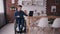 Man in wheelchair using modern computer at home