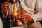 Man in a white cotton working suit holding lit kerosene lamp in