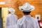 Man in white dress with hat at altar