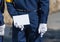 A man in white gloves holds a white sheet behind his back, Kyoto, Japan. Copy space for text. Frame for text.