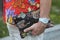 Man with white and golden Ice watch, bag with tiger and snake design and red shirt with floral decoration before