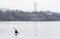 A man in a white kayak near the city riverbank02