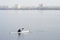 A man in a white kayak near the city riverbank03