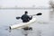 A man in a white kayak near the city riverbank04