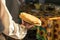 A man in a white national Slavic costume holds a plate of pancakes in his hand. Russian national food. Maslenitsa. Shrovetide