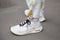 Man with white Nike foam shoes and trousers with butterflies design before Fendi fashion show, Milan Fashion