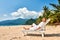 Man in white relaxing in sun bed on beach