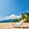 Man in white relaxing in sun bed on beach