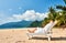 Man in white relaxing in sun bed on beach