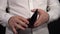 A man in a white shirt on a black background shows an empty, leaky old wallet