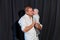 A man in a white shirt kisses a beautiful baby girl. Father`s love for his daughter