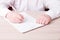 a man in a white shirt signs a contract, a labor contract legal work in the service sector,