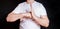 A man in a white t-shirt showing a sign of respect during a fight, ready to fight. Symbols, signs.