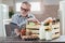 Man who just got package of organic food, using digital tablet.