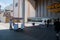 Man who pushes a famous rolling chair waits for a tourist to request a ride on the Atlantic City Boardwalk in front of the Hard