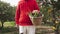 Man with a wicker basket with freshly picked vegetables