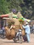 A man will rides a motorcycle overloaded with straw baskets