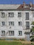 Man at the window in multistorey house in Teriberka village