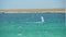 Man Windsurfing in the water during a sunny summer day. Shot. Beautiful view of the sea and windsurfer on a Sunny day