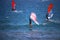 Man wing foiling among windsurfers at the Atlantic ocean