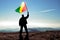 man winner waving Republic of Congo flag on top of the mountain peak