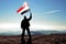 Man winner waving Yemen flag on top of the mountain peak