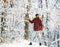 A man in a winter forest. A woodman working in the forest. Man inspecting trees in wood. Man in winter landscape