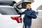 Man wipes trunk of american SUV car with a microfiber cloth after washing in cold weather