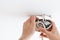 Man wiring ceiling light on white background