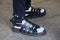 Man with Wolftotem black leather sandals with white socks before MSGM fashion show, Milan Fashion Week street