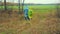 A man and a woman agronomists in a raincoat walking on a plowed field