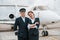 Man with woman. Aircraft crew in work uniform is together outdoors near plane