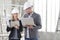 Man and woman architects or engineers with computer work together in the inside the construction building site