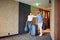 Man and woman arriving at hotel lobby with suitcase at vacation