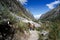 Man and woman backpacker in the Andes of Peru return from the remote wilderness back to civilization at a modern road head