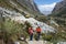 Man and woman backpacker in the Andes of Peru return from the remote wilderness back to civilization at a modern road head