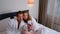 Man and woman in bathrobes making photos on smartphone eating in hotel.