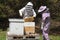Man and woman bee keepers opening hive
