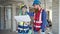 Man and woman builders reading house project speaking by walkie-talkie at construction site