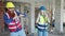 Man and woman builders smiling confident dancing at construction site