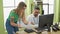 Man and woman business workers using computer arguing at office