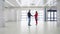 Man and a woman businesswoman shake hands in an empty hangar, the general plan. Successful negotiations business people