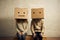 Man and woman with cardboard boxes on head. Generative AI