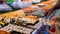 Man and Woman Choosing Fresh Sushi Set from Night Market