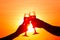 Man and woman clanging wine glasses with champagne at sunset