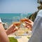 Man and woman clanging wine glasses with white wine